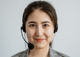 Portrait of a smiling customer service representative with a headset.