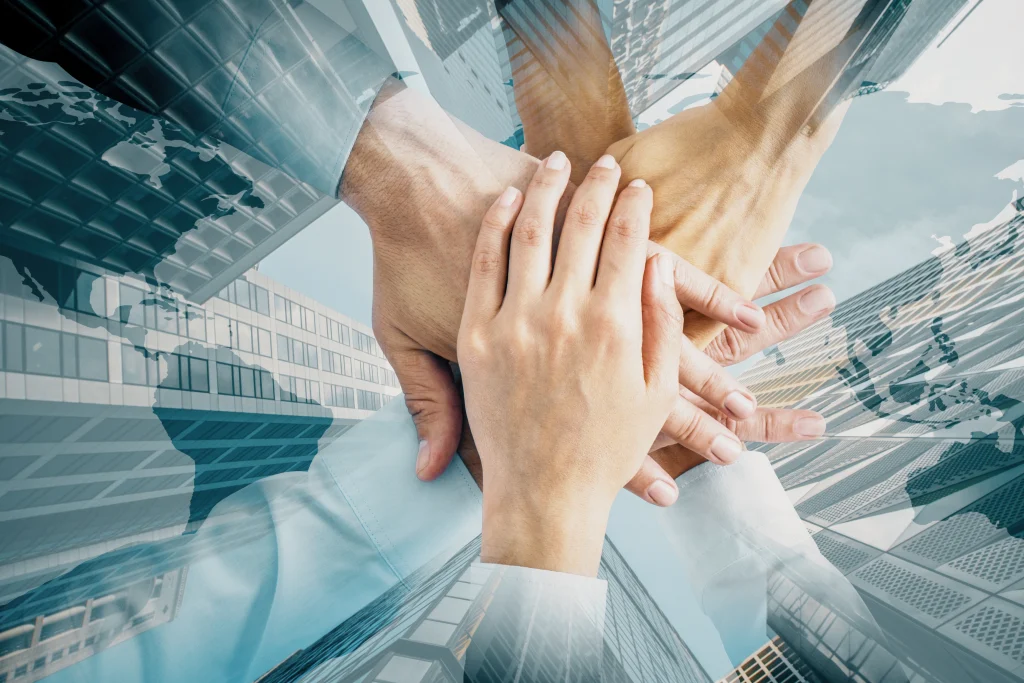 teamwork hands with building background represents 2026 01 11 08 40 03 utc